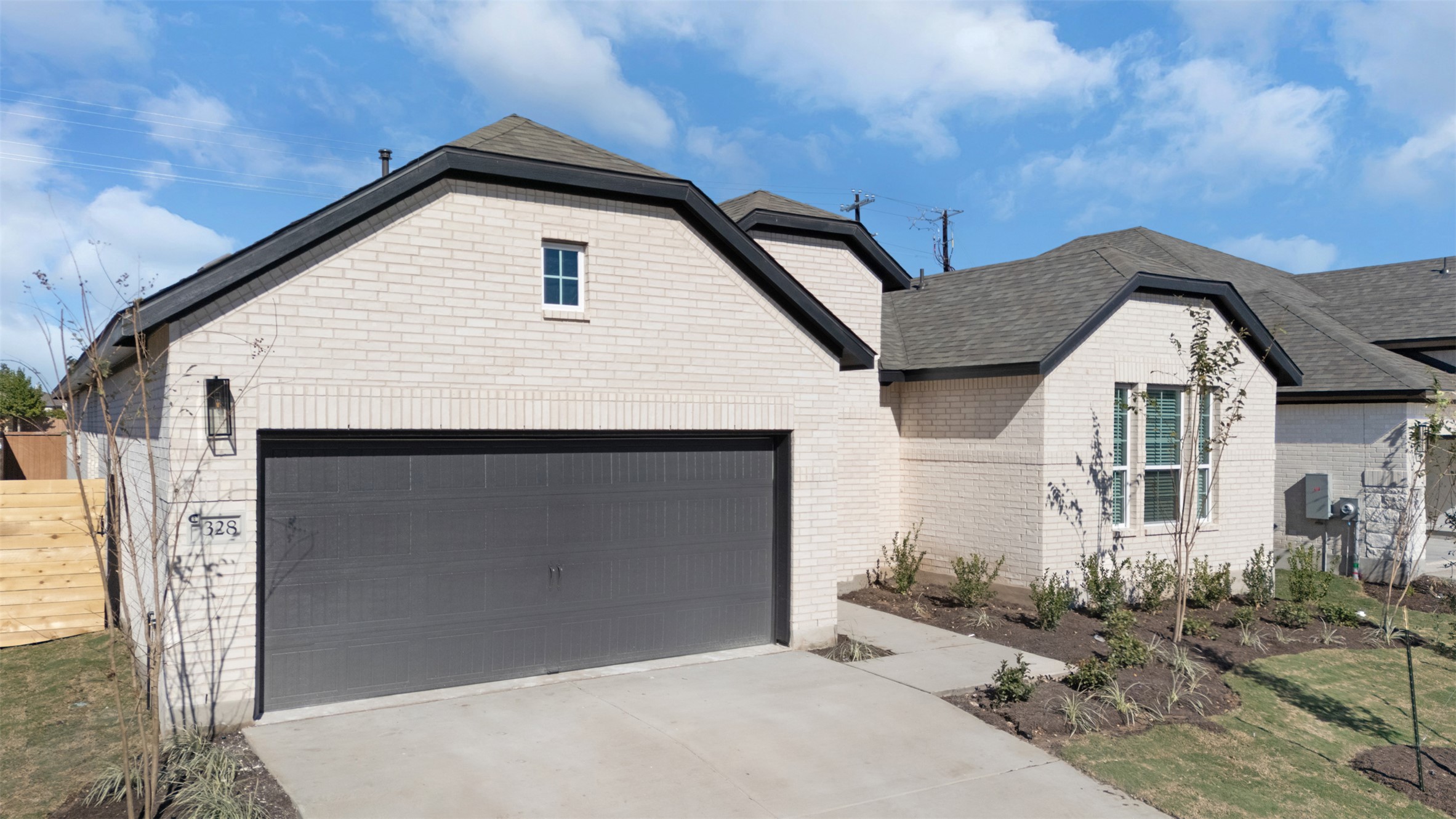 328 Ridgewell Loop Georgetown, TX 78633 - Photo 3 of 28 View of front of home featuring a garage, a shingled roof, concrete driveway, and brick siding