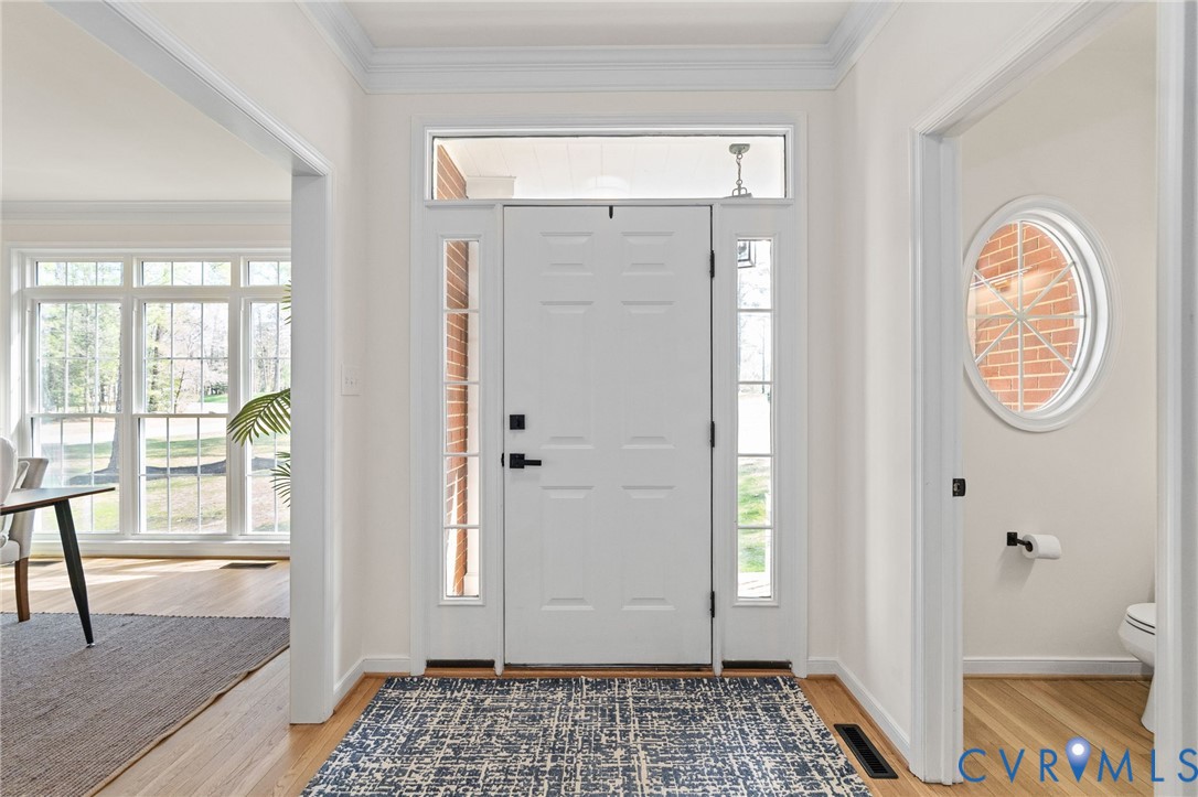 14200 Princess Mary Road Chesterfield, VA 23838 - Photo 11 of 83 a view of a hallway with wooden floor and a livingroom