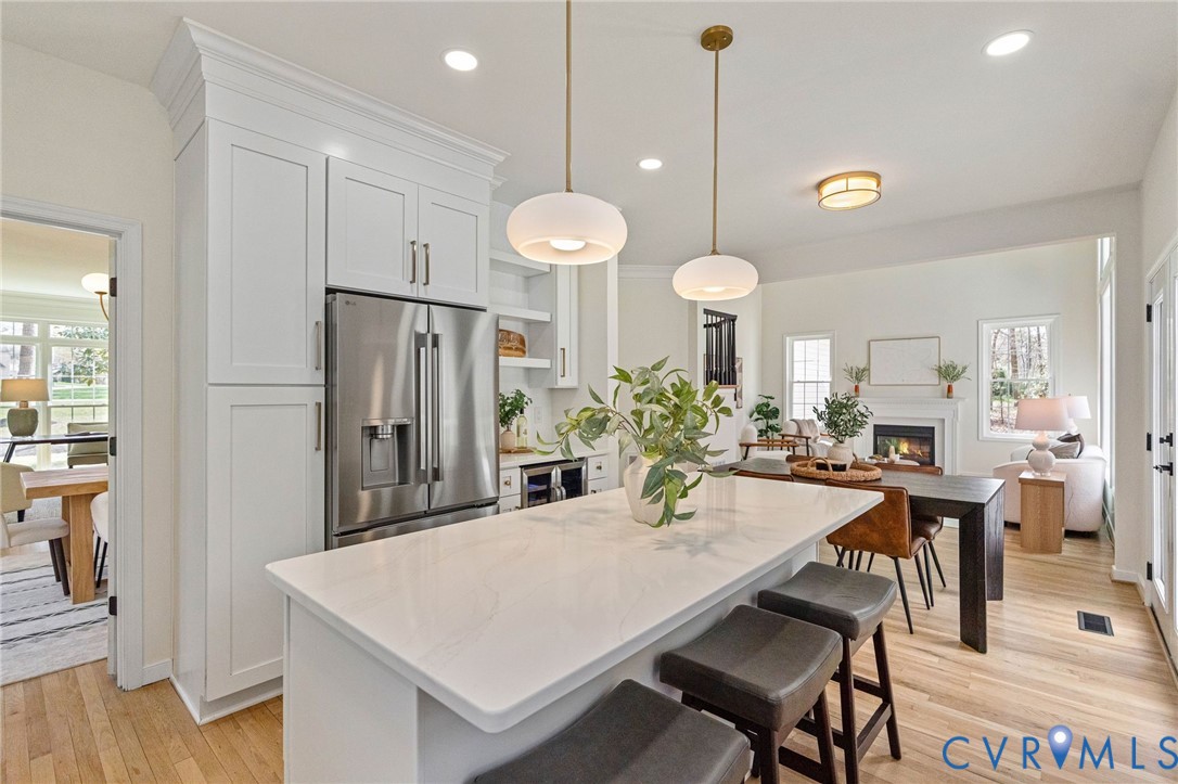 14200 Princess Mary Road Chesterfield, VA 23838 - Photo 25 of 83 a kitchen with stainless steel appliances kitchen island granite countertop a dining table chairs and a refrigerator