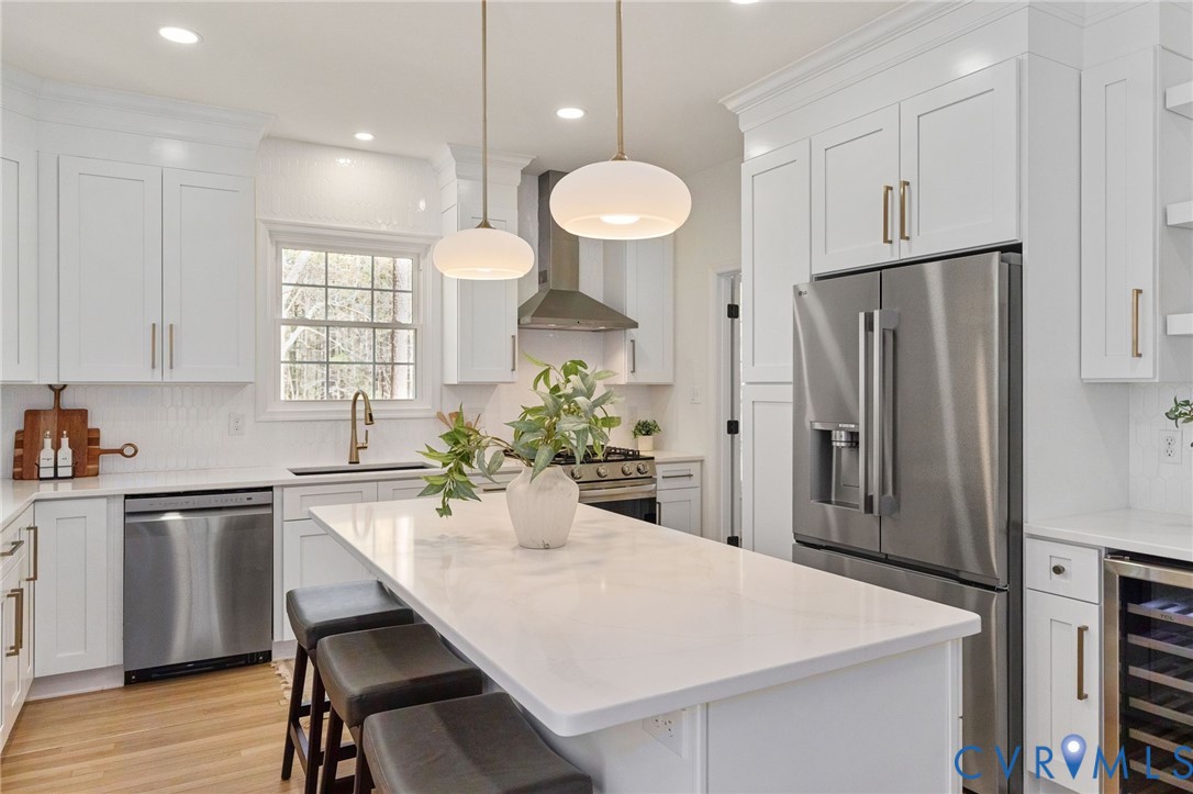 14200 Princess Mary Road Chesterfield, VA 23838 - Photo 26 of 83 a kitchen with stainless steel appliances a dining table chairs and white cabinets