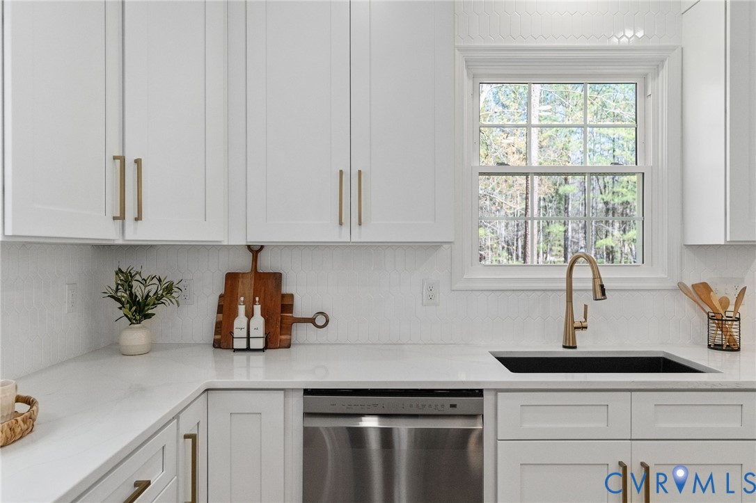 14200 Princess Mary Road Chesterfield, VA 23838 - Photo 28 of 83 a kitchen with white cabinets a sink and a window