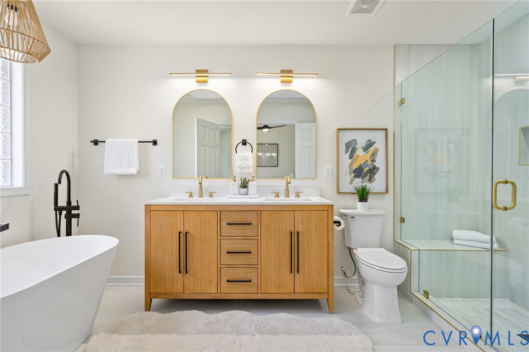 14200 Princess Mary Road Chesterfield, VA 23838 - Photo 45 of 83 a bathroom with a double vanity sink a toilet and a mirror