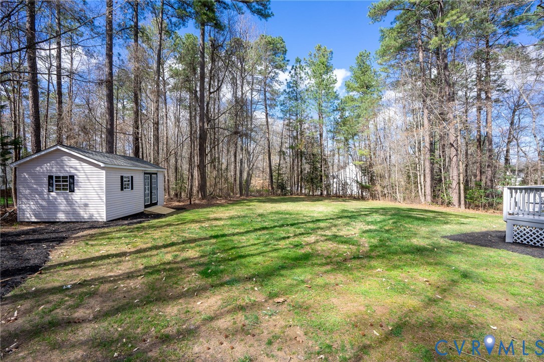 14200 Princess Mary Road Chesterfield, VA 23838 - Photo 55 of 83 a backyard of a house with large trees and wooden fence