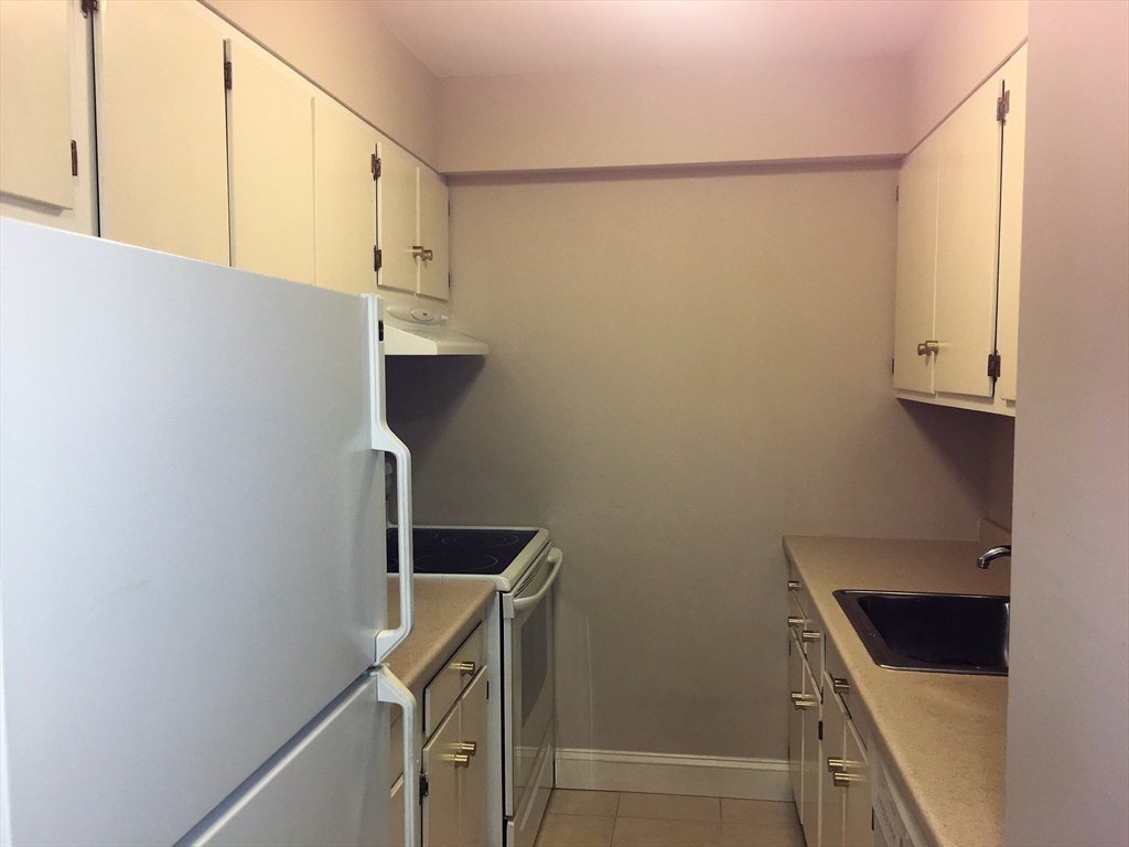 12 Inman Street, Unit 52 Cambridge, MA 02139 - Photo 4 of 12 a kitchen with a refrigerator and a stove