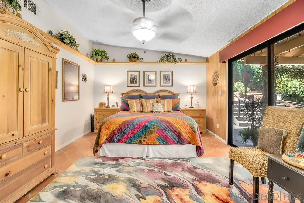 9468 Domer Road Santee, CA 92071 - Photo 11 of 25 a bedroom with a bed and a chandelier