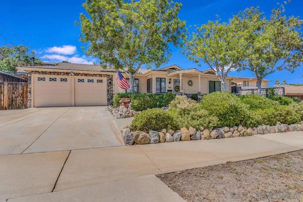 9468 Domer Road Santee, CA 92071 - Photo 2 of 25 a front view of a house with a yard and a garage
