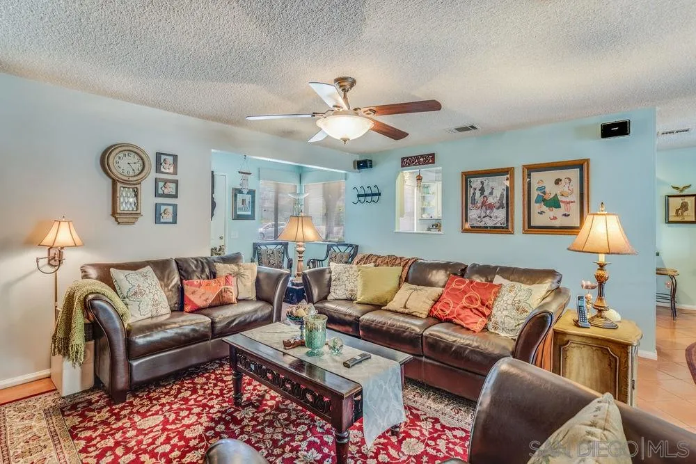 9468 Domer Road Santee, CA 92071 - Photo 4 of 25 a living room with furniture and a lamp
