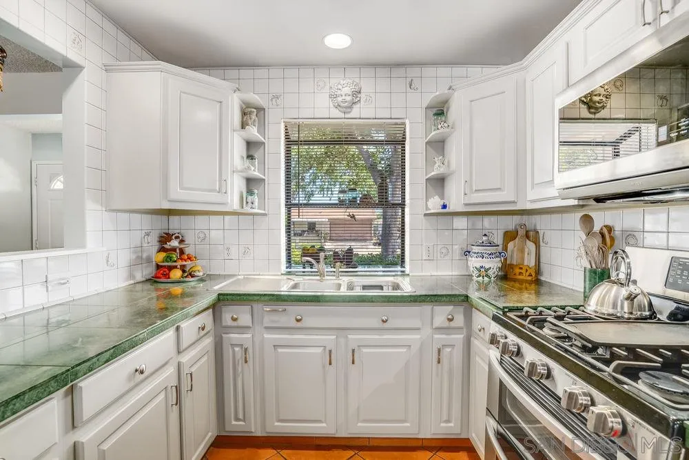 9468 Domer Road Santee, CA 92071 - Photo 9 of 25 a kitchen with stainless steel appliances granite countertop a stove a sink dishwasher and cabinets with wooden floor