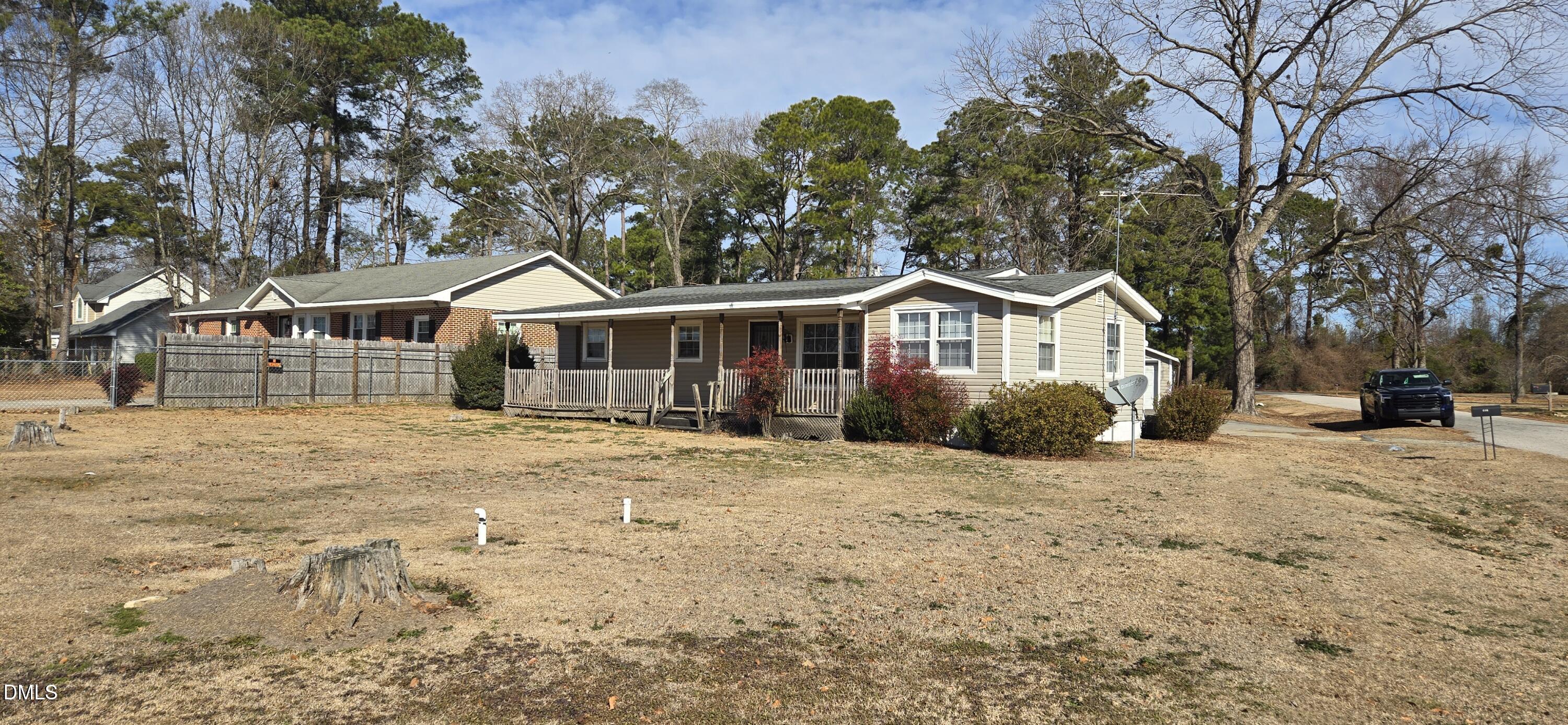480 5 Bridge Road Clinton, NC 28328 - Photo 2 of 23 a front view of a house with a yard covered with snow and trees