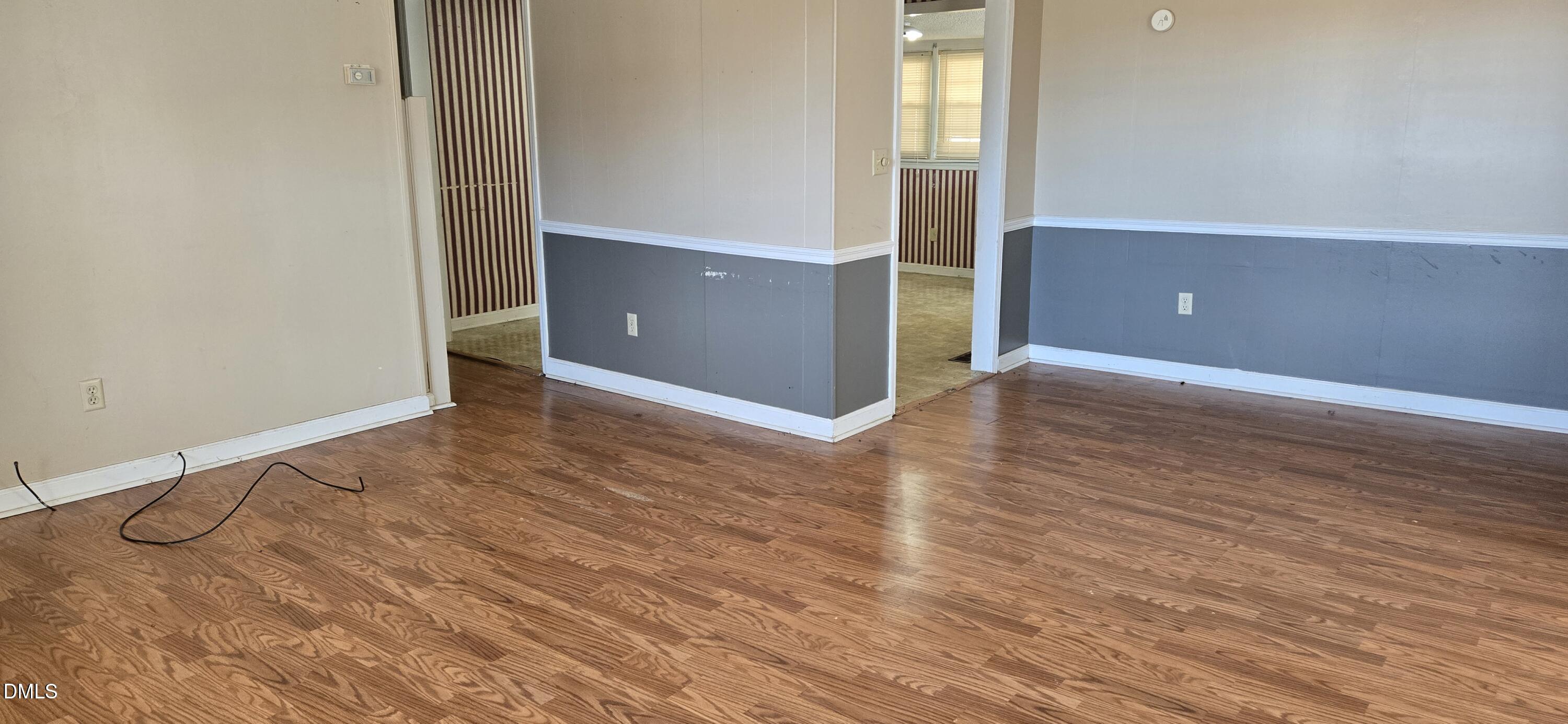 480 5 Bridge Road Clinton, NC 28328 - Photo 8 of 23 an empty room with wooden floor and windows