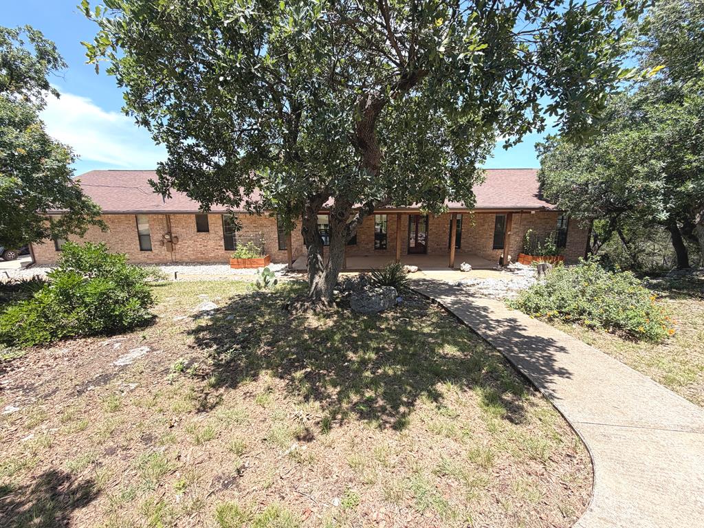 707 Rimrock Road Kerrville, TX 78028 - Photo 2 of 55 a front view of a house with a yard covered in snow
