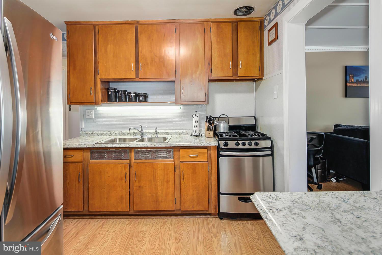 12304 Middle Road Silver Spring, MD 20906 - Photo 6 of 30 a kitchen with stainless steel appliances granite countertop a refrigerator stove and sink