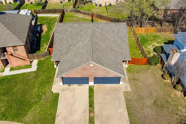a aerial view of a house with a yard