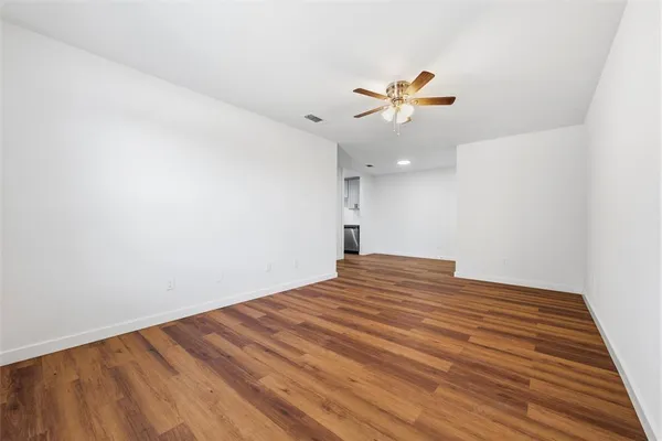wooden floor in an empty room with a window