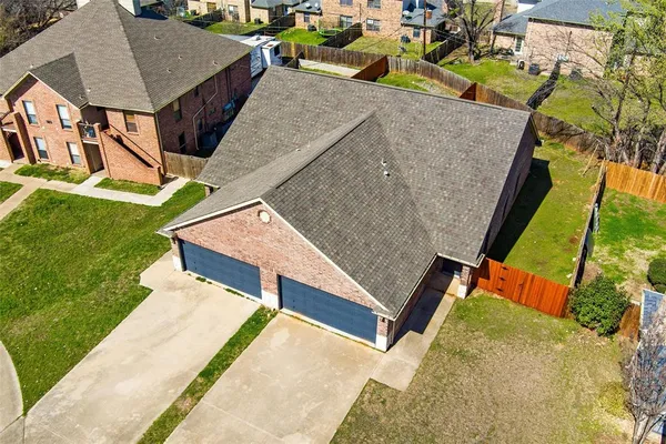 an aerial view of a house with swimming pool and porch