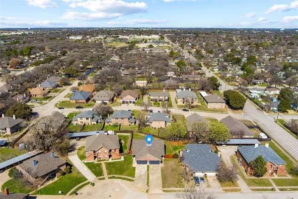 an aerial view of residential houses with outdoor space