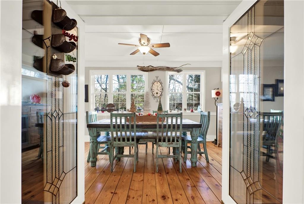 1050 Robinson Road Dahlonega, GA 30533 - Photo 13 of 28 a view of a dining room and livingroom with furniture wooden floor a chandelier
