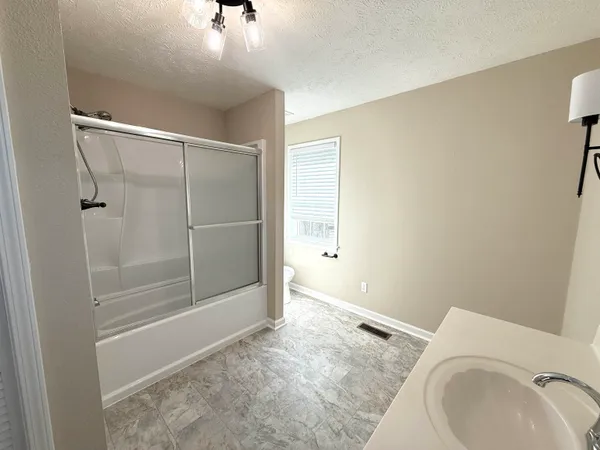 a bathroom with a bathtub and shower