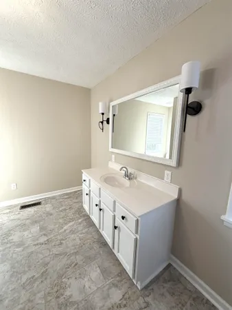 a bathroom with a double vanity sink and mirror