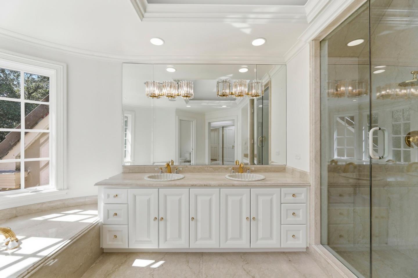 14113 Pike Road Saratoga, CA 95070 - Photo 42 of 78 a bathroom with a granite countertop sink a large mirror and shower