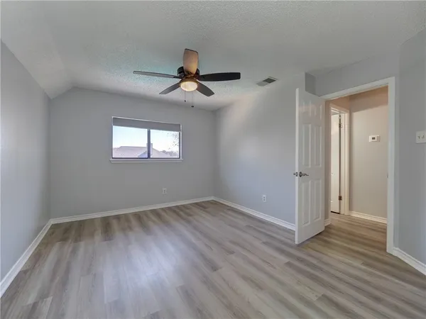 a view of room with a ceiling fan and window
