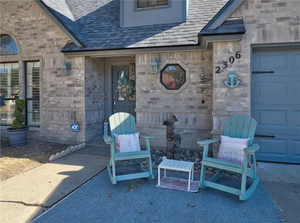 a front view of a house with outdoor seating and outdoor seating