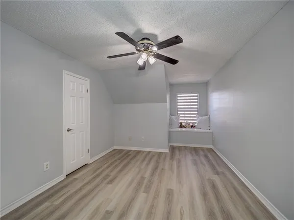 a view of a livingroom with a ceiling fan window and a chandelier