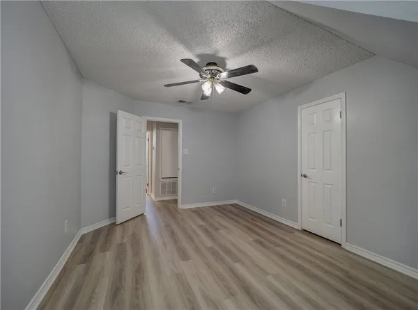 a view of an empty room and wooden floor
