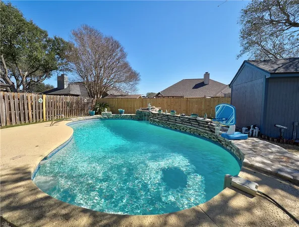 a view of backyard with wooden fence