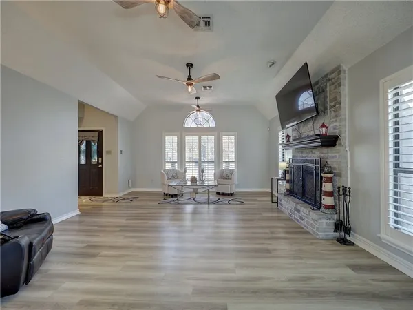 a living room with furniture a fireplace and a flat screen tv