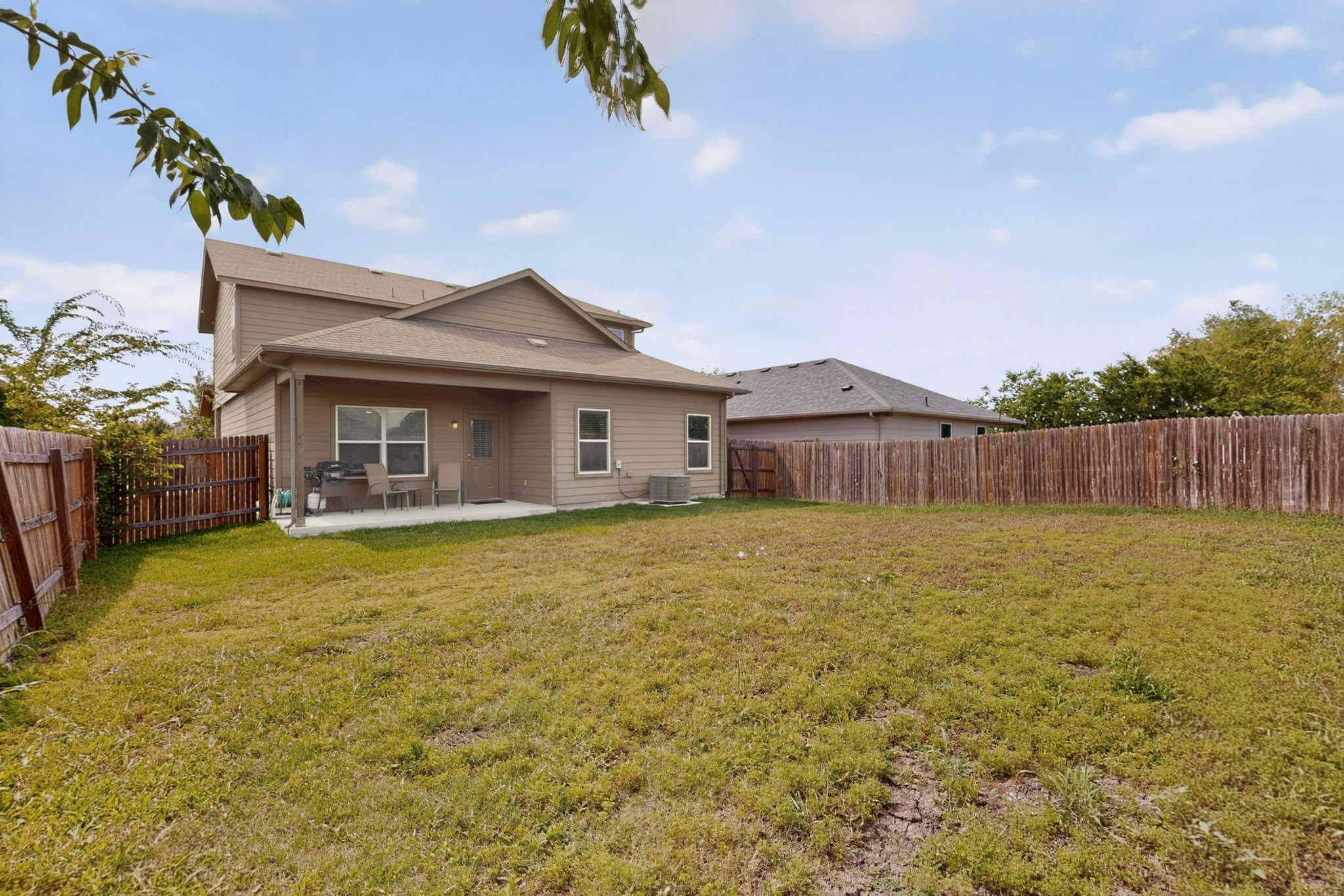 14513 Esker Road Manor, TX 78653 - Photo 34 of 38 A spacious backyard with a private patio offers ample outdoor living.