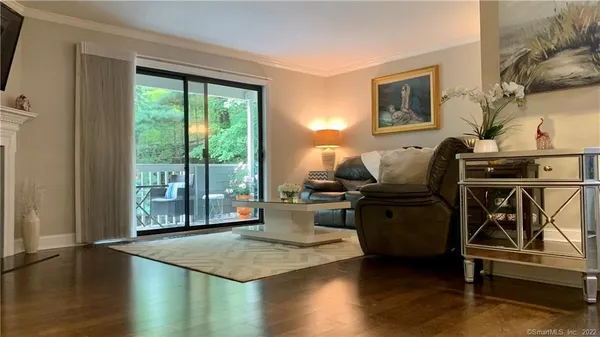 a living room with furniture and a floor to ceiling window
