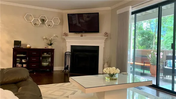 a living room with furniture a fireplace and a flat screen tv
