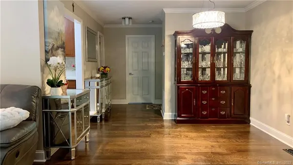 a view of a livingroom with furniture and hardwood floor