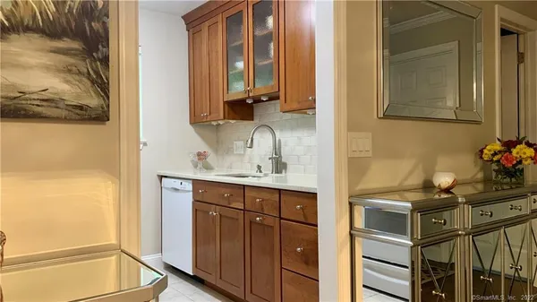 a white refrigerator freezer sitting inside of a kitchen