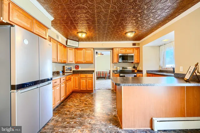 a kitchen with granite countertop lots of counter top space and stainless steel appliances