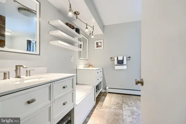a bathroom with a sink a mirror and a toilet