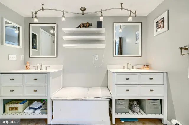 a bathroom with a sink vanity and mirror