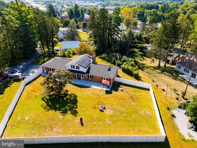 an aerial view of a swimming pool with outdoor seating