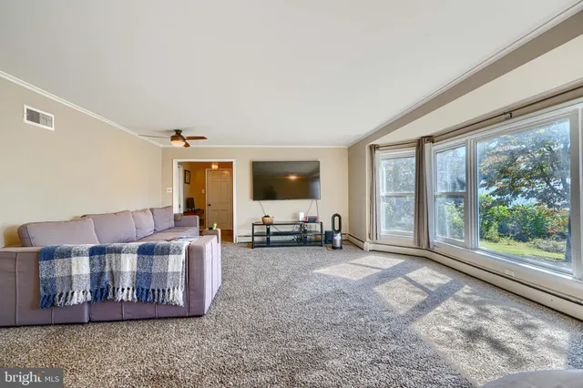 a living room with furniture and large windows
