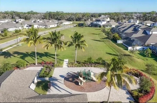 an aerial view of residential houses with outdoor space and swimming pool