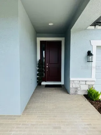 an empty room with closet and windows