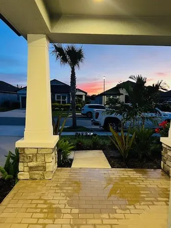 a view of a swimming pool with potted plants