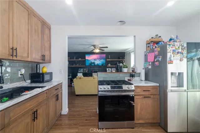 a kitchen with stainless steel appliances granite countertop a refrigerator stove and sink