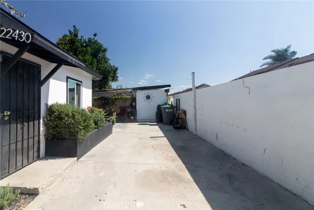 a house with potted plants in front of it