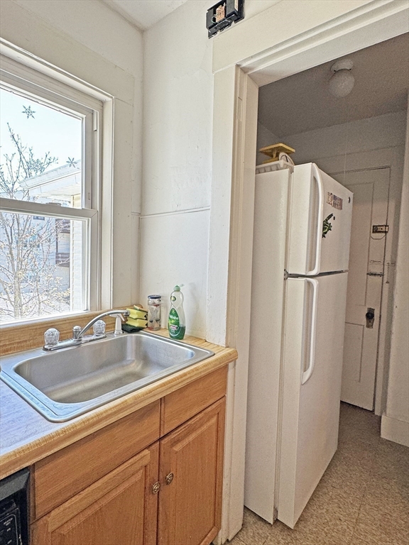 12-14 Nottingham Street Newton, MA 02459 - Photo 15 of 29 a kitchen with stainless steel appliances granite countertop a refrigerator and a sink