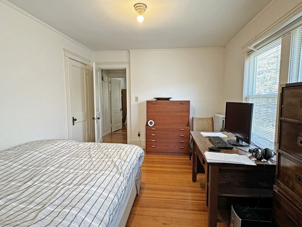 12-14 Nottingham Street Newton, MA 02459 - Photo 18 of 29 a bedroom with a bed and a computer on a desk
