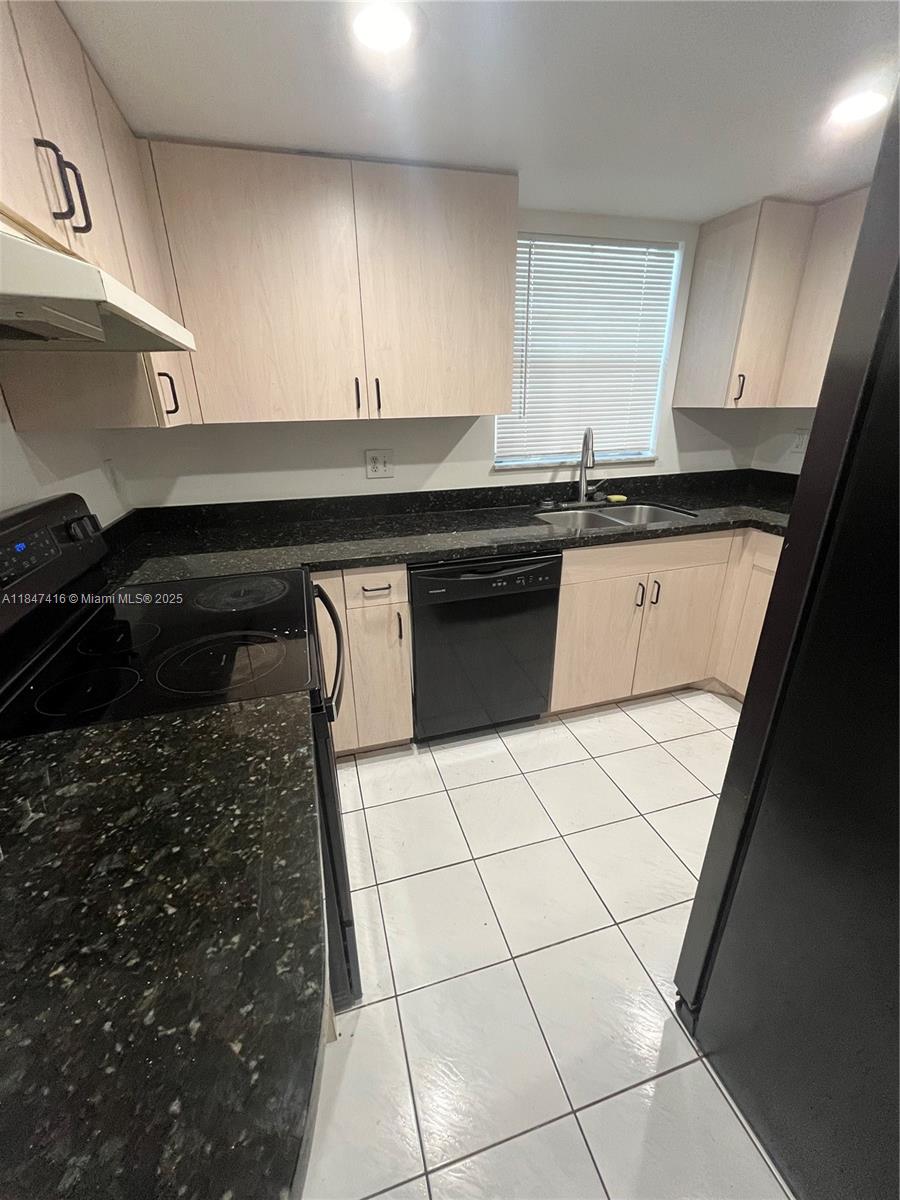 8404 West Sample Road, Unit 131 Coral Springs, FL 33065 - Photo 19 of 36 a kitchen with a sink and cabinets