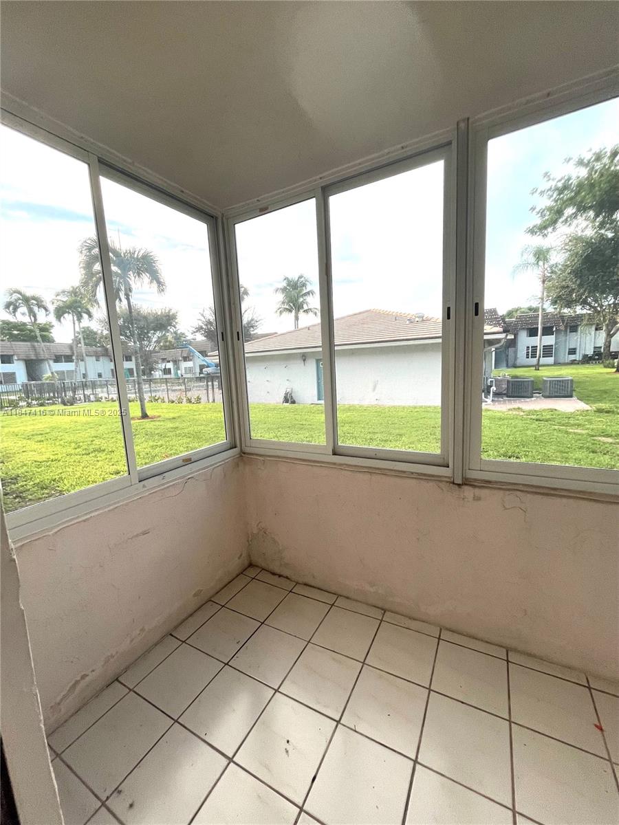 8404 West Sample Road, Unit 131 Coral Springs, FL 33065 - Photo 32 of 36 a view of an empty room with a large window
