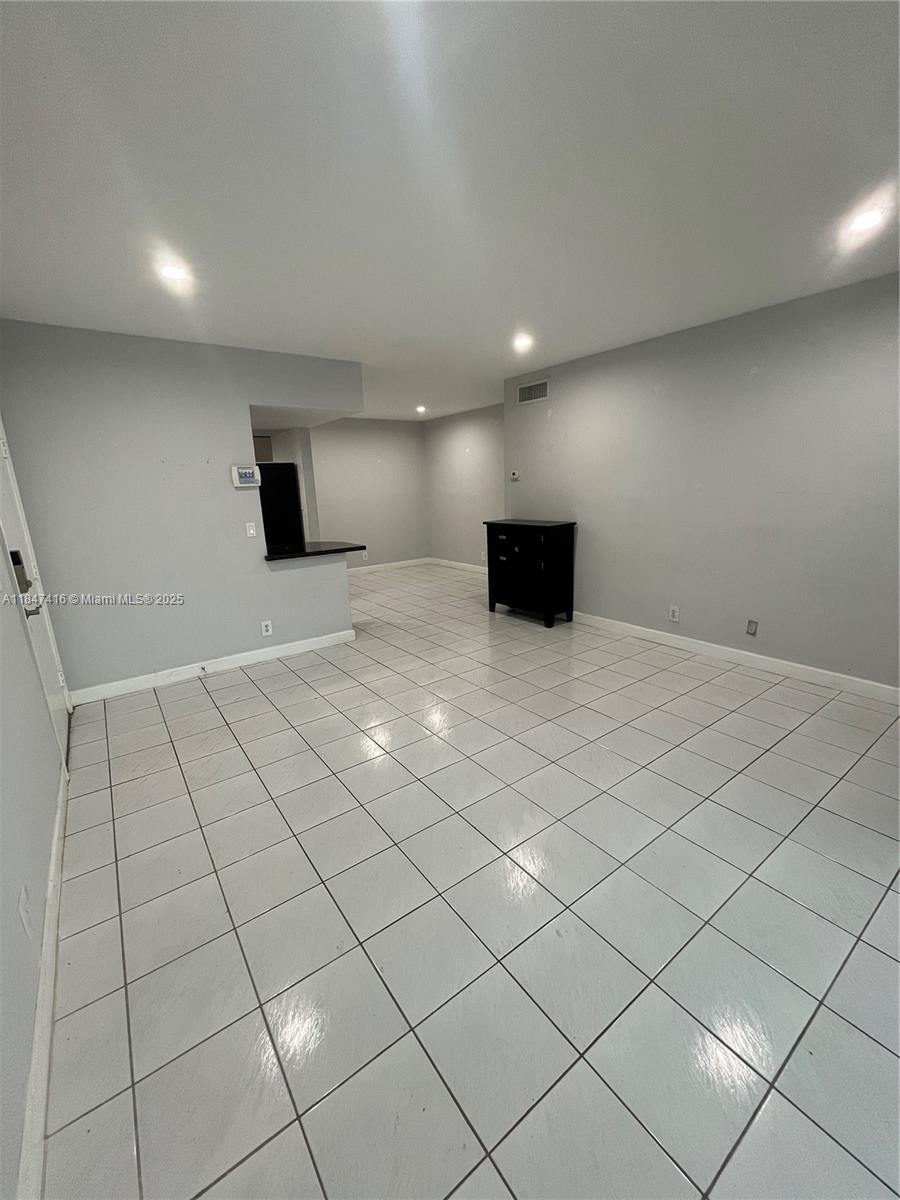8404 West Sample Road, Unit 131 Coral Springs, FL 33065 - Photo 33 of 36 a view of an empty room with wooden floor